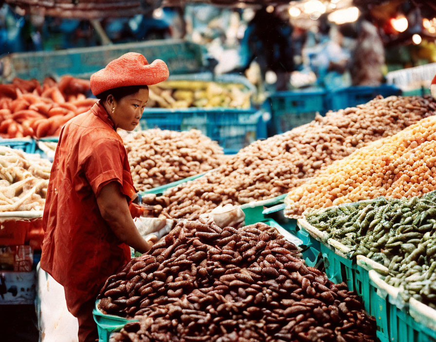 Woman in Red Hat Organizing Fresh Produce at Market Stall