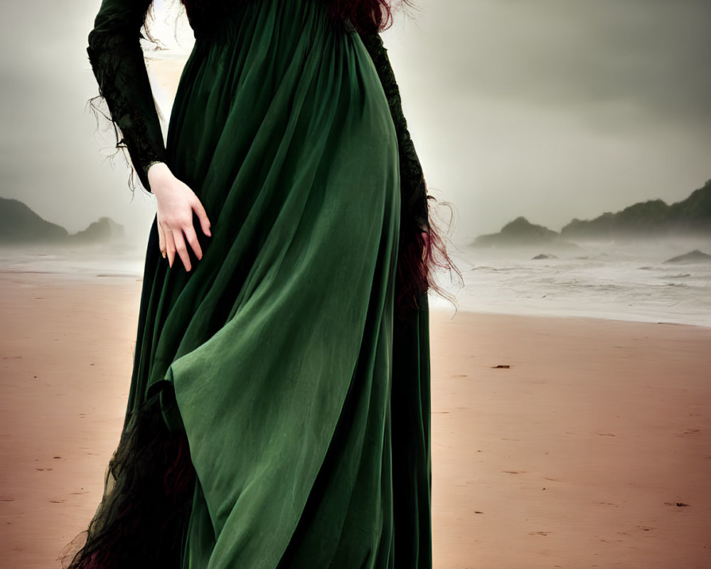 Long Red-Haired Person in Green Dress on Beach under Cloudy Sky