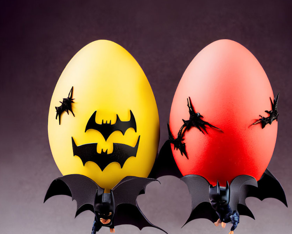 Yellow and red Easter eggs with bat silhouettes on rocky surface