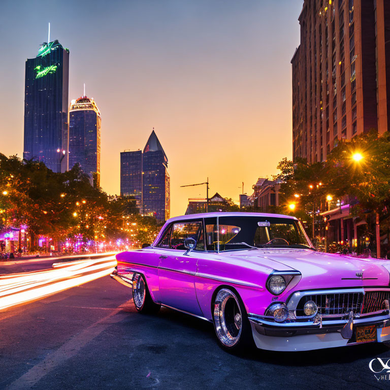 Vintage car parked on city street at twilight with skyscrapers and traffic light trails.