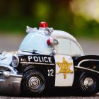 Ornate Toy Car with Gemstones and Festive Hat on Wintry Background