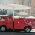 Vintage Red Car on Stylized Street with White Umbrellas