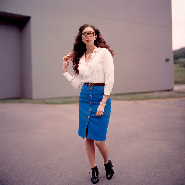 Woman in Glasses and Stylish Outfit with Curly Hair