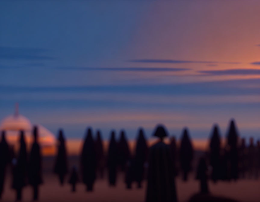 Blurred figures against colorful twilight sky on a beach