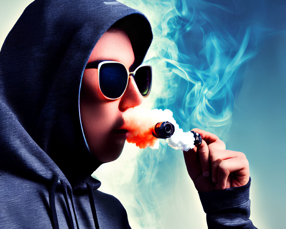 Person in Hoodie Exhaling Blue Smoke with E-Cigarette