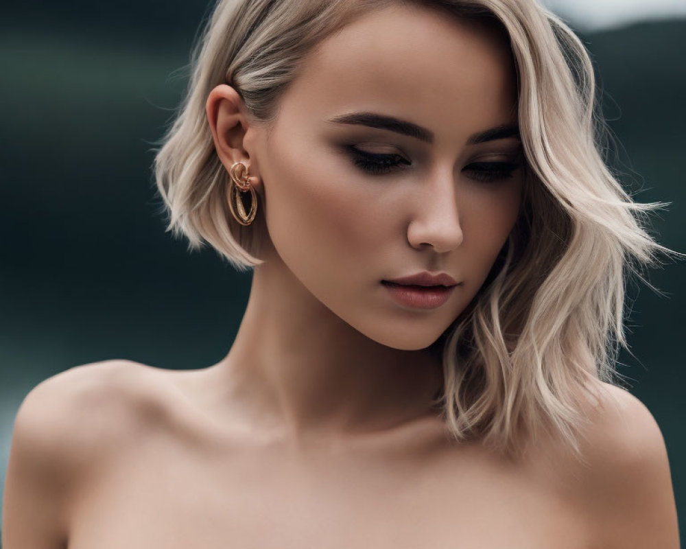 Blonde woman portrait with hooped earrings and natural background