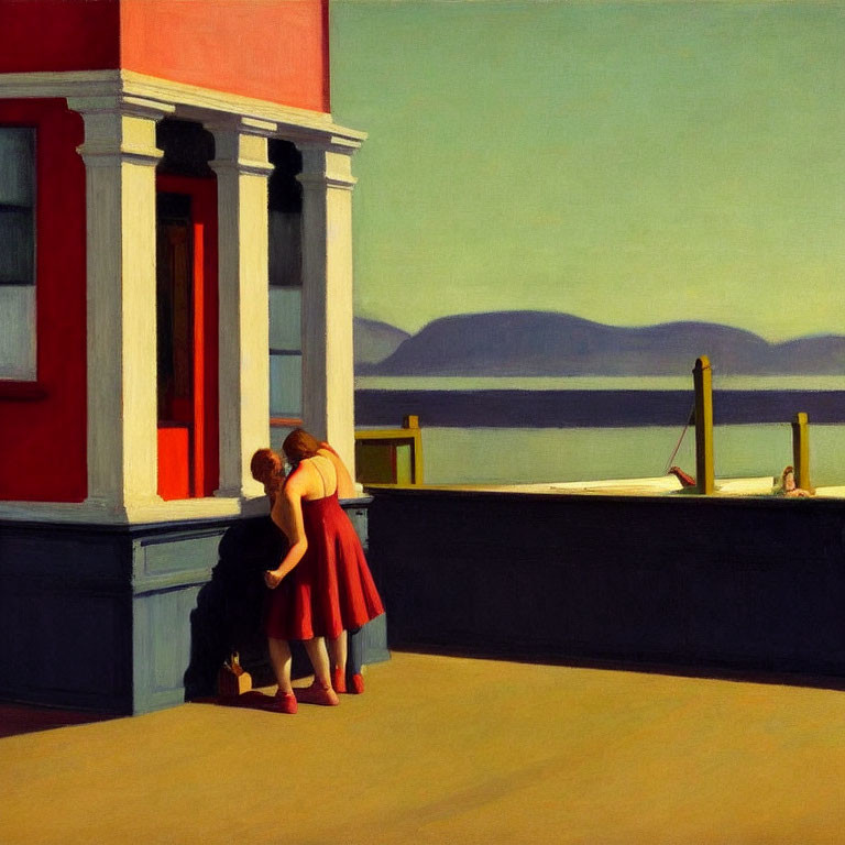 Two women in red dresses chat near building with sea view.