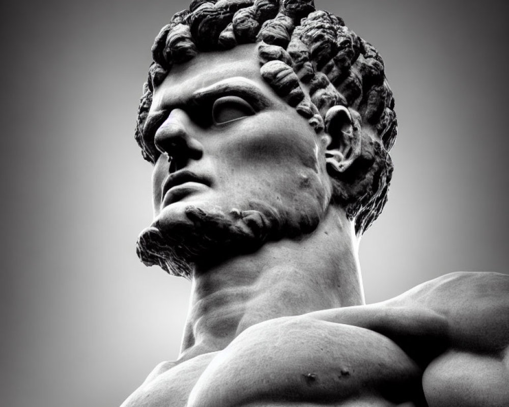 Monochrome image of muscular male sculpture with curly hair