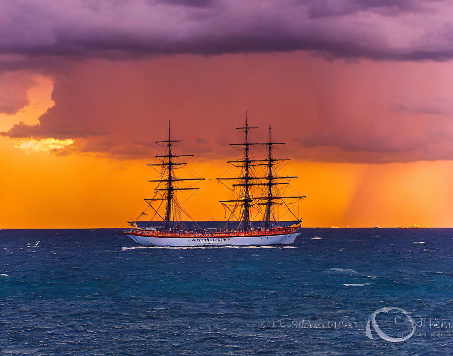 Tall ship with multiple masts sailing at sunset