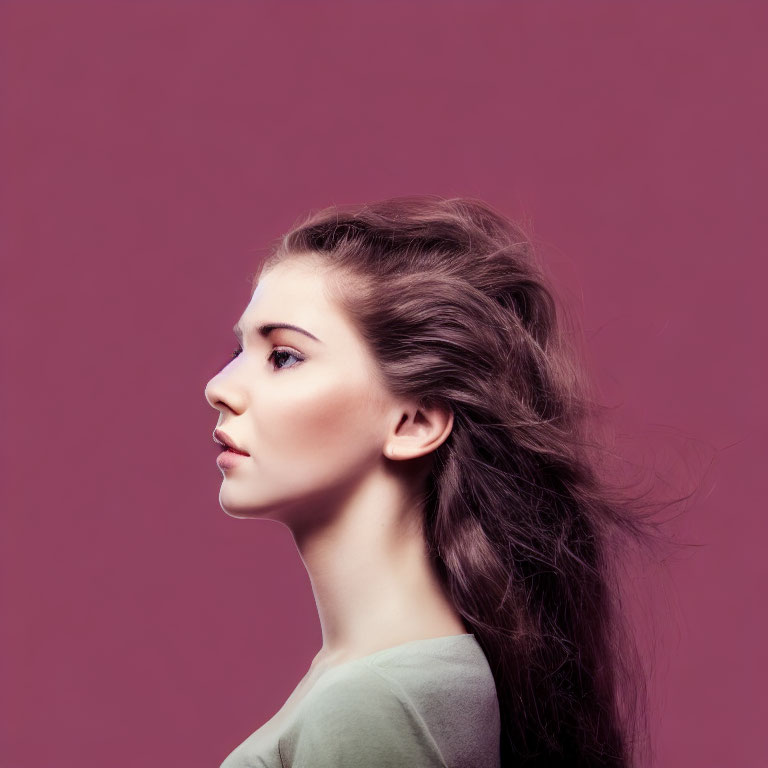 Young Woman with Voluminous Brunette Hair on Purple Background