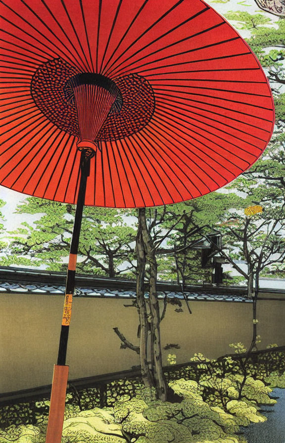 Traditional Japanese umbrella in vibrant red against serene garden backdrop