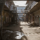 Foggy cobblestone alley with vintage lanterns and archways