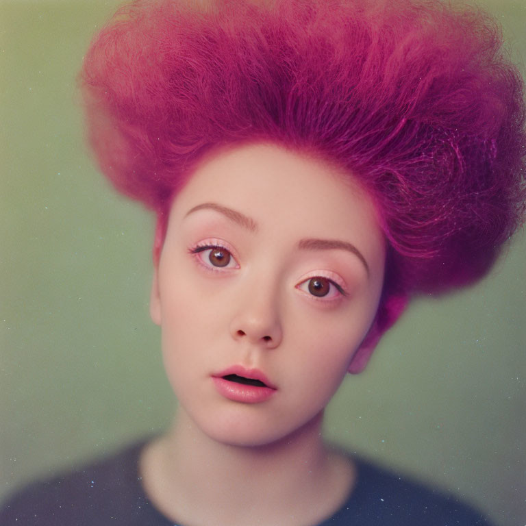 Person with Large Expressive Eyes and Purple Afro Hair on Muted Green Background