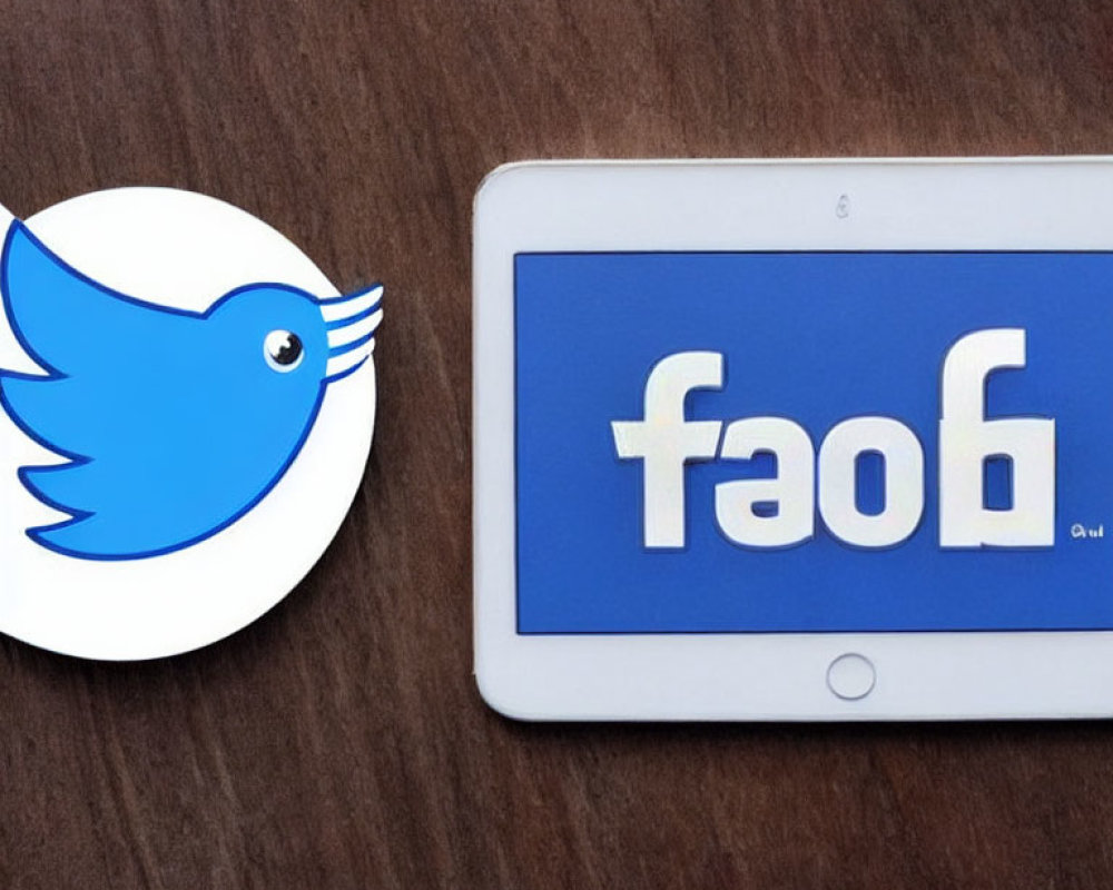 Social media logo stickers on tablet: Twitter bird next to flipped Facebook logo "faof".