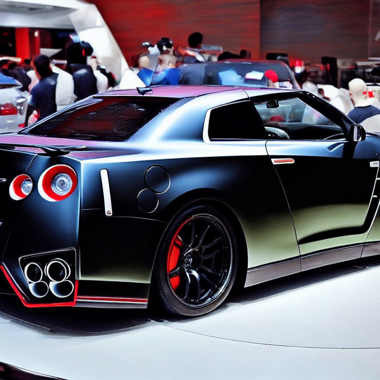 Black Sports Car with Unique Tail Lights and Large Exhausts at Auto Show