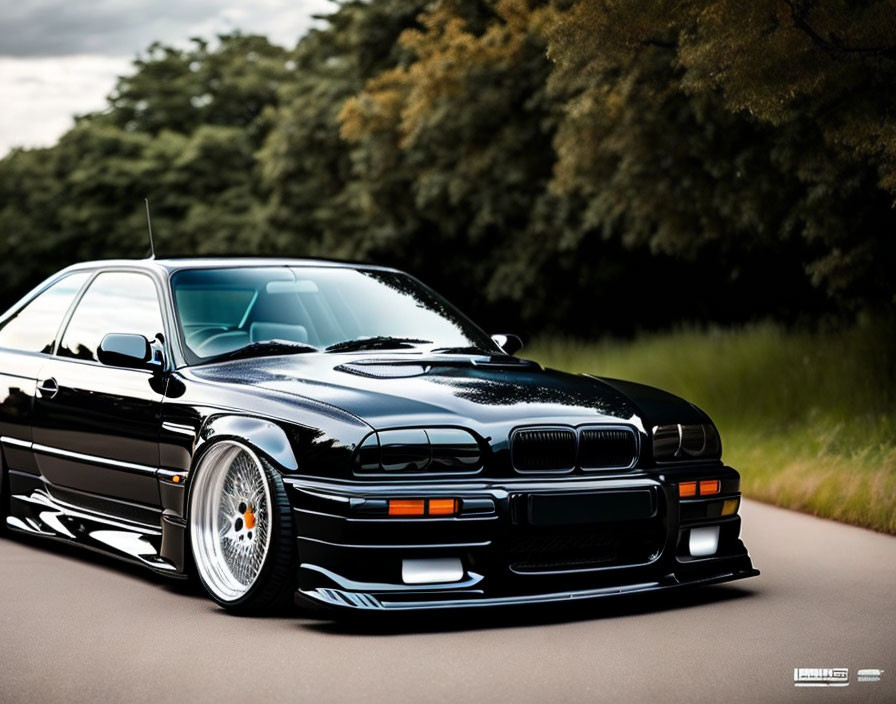 Modified Black BMW E36 with Aftermarket Wheels and Body Kit