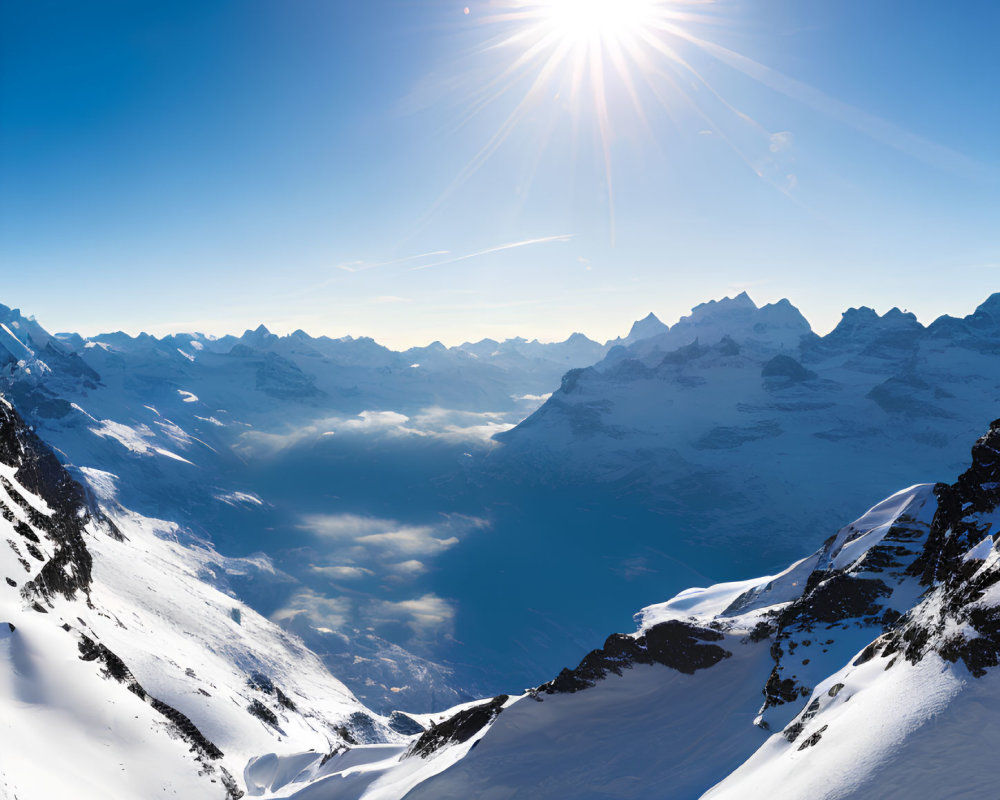 Snow-covered mountain peaks under dazzling sun and blue skies.