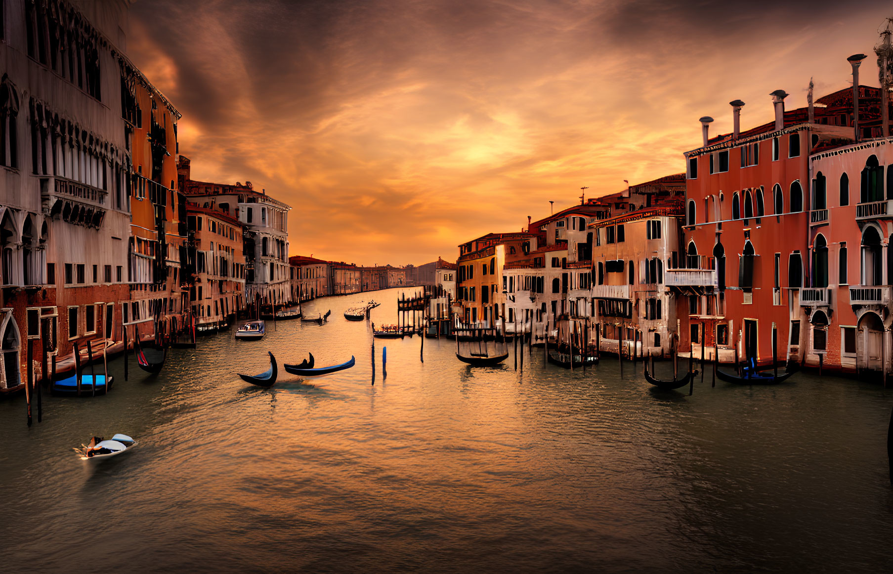 Scenic Venetian canal at sunset with historic buildings and gondolas