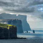 Secluded house on cliff with waterfall, under moody skies