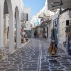 Traditional white-washed village alley with pebbled pattern under clear blue sky