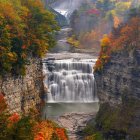 Autumn waterfall surrounded by vibrant foliage in forested canyon