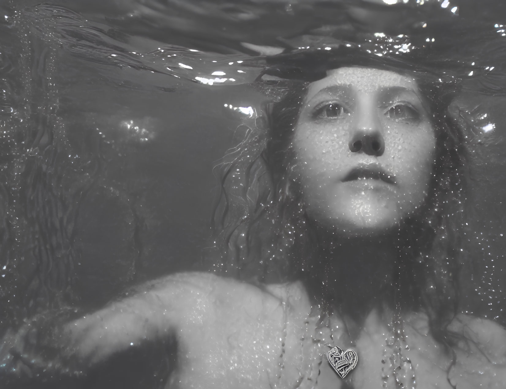 Monochrome image: Woman in water with serene expression