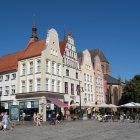 Twilight evening market with illuminated stalls and historic buildings