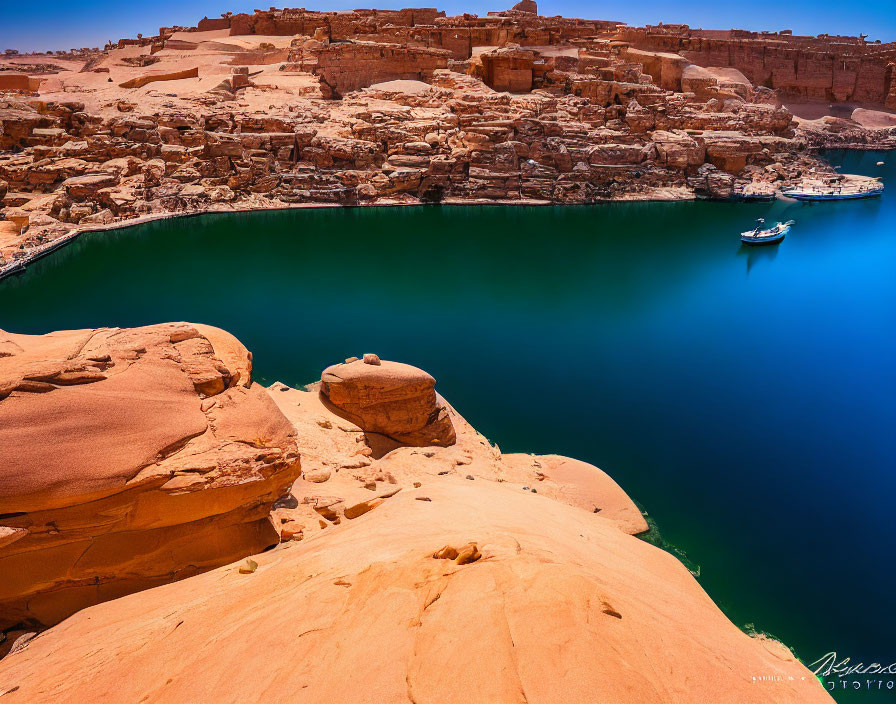 Blue Lake and Sandstone Cliffs with Boat on Clear Sky