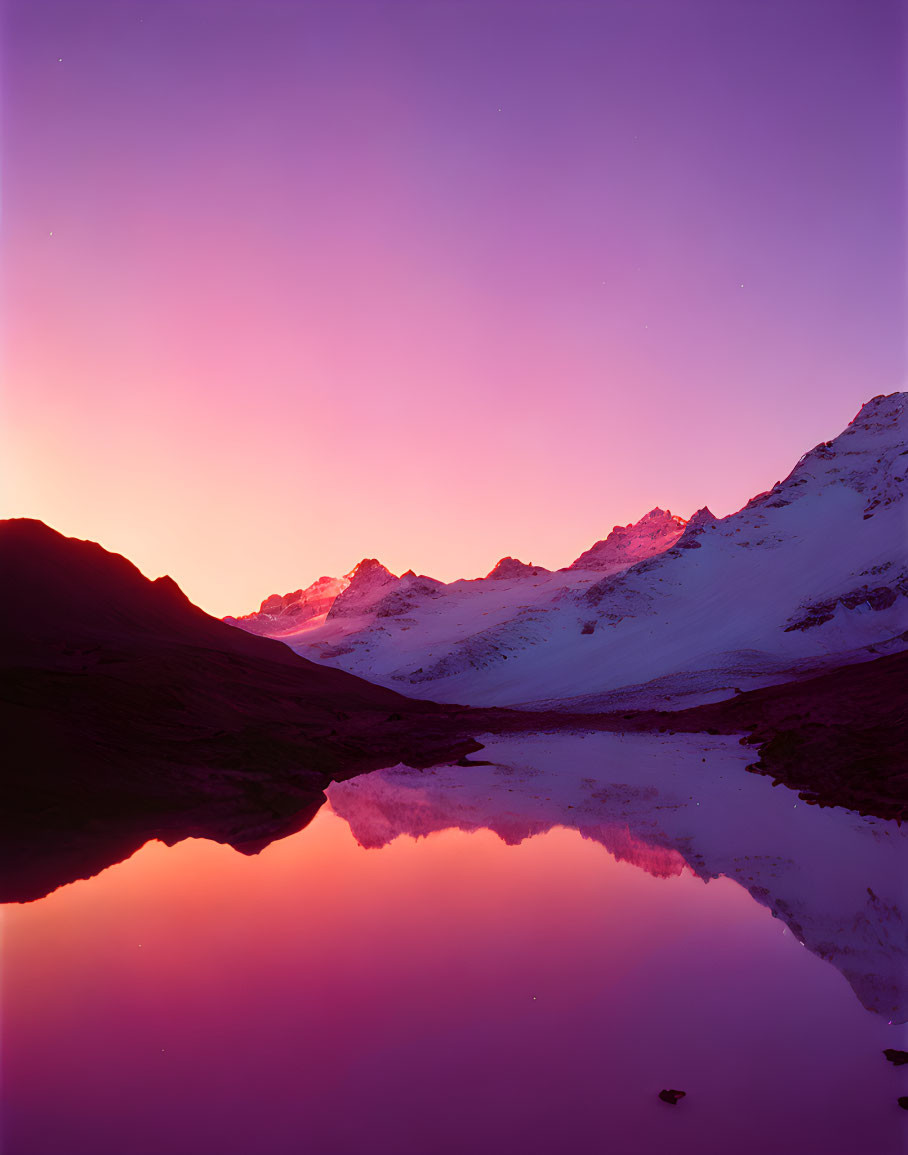 Mountain lake sunset with snow-capped peaks