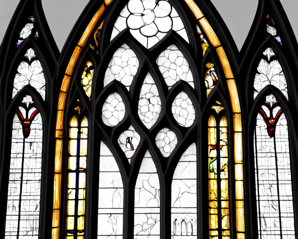 Intricate Gothic stained glass windows in stone wall with pointed arches