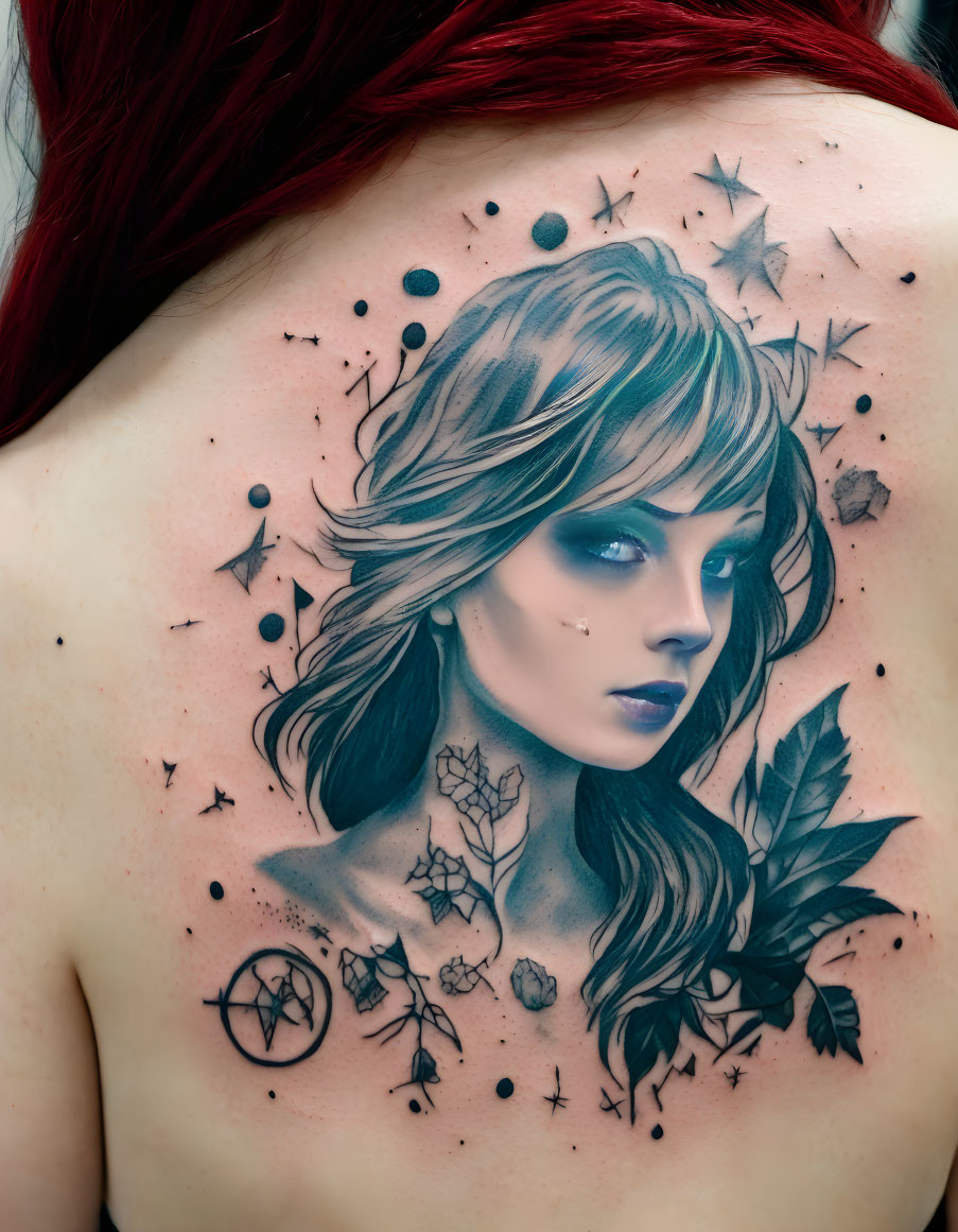 Woman's Face Tattoo Surrounded by Stars, Leaves, and Geometric Shapes on Back