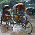 Detailed Illustration: Passengers in Rickshaws with Umbrellas in Vibrant Rainy Street Scene