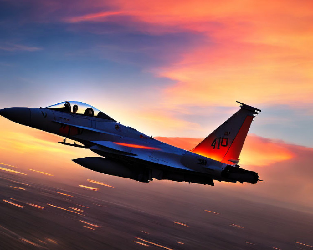 Fast fighter jet in motion against vibrant sunset sky with blurred ground.