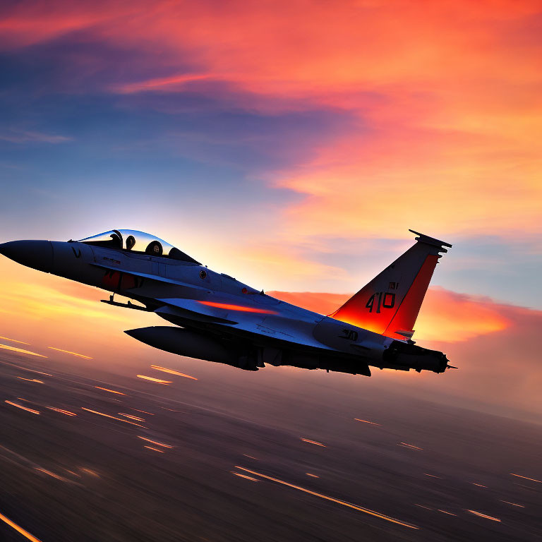 Fast fighter jet in motion against vibrant sunset sky with blurred ground.