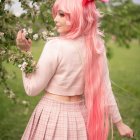 Ethereal figure with pink hair in serene meadow