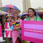 Vibrant People in Elaborate Costumes with Props and Umbrellas