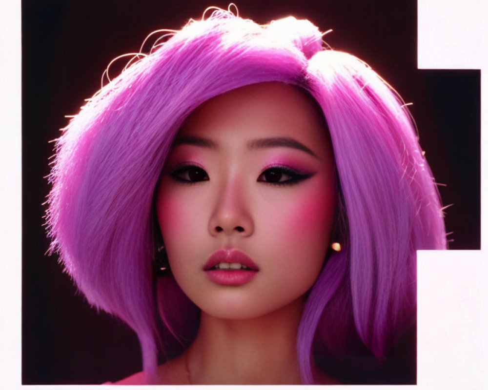 Vibrant purple hair and bold pink makeup on a woman against a dark backdrop