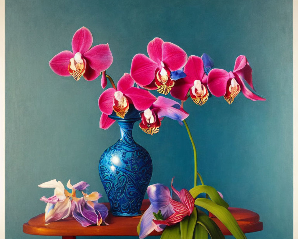 Pink orchids in blue vase on wooden table against teal background