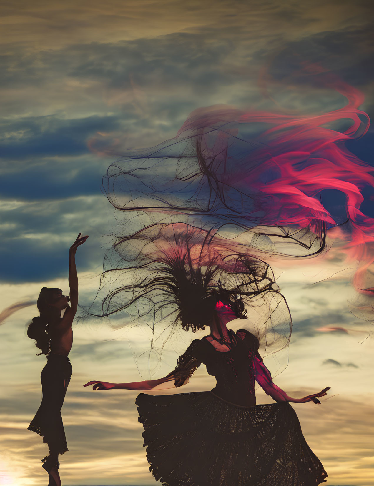 Two women dancing outdoors with flowing hair and colorful smoke-like dresses under a dramatic sky