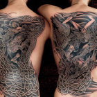 Elaborate red and blue dragon tattoos on two individuals' backs