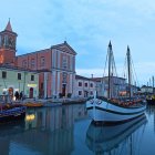 Historical port at twilight with sailboats and vintage buildings