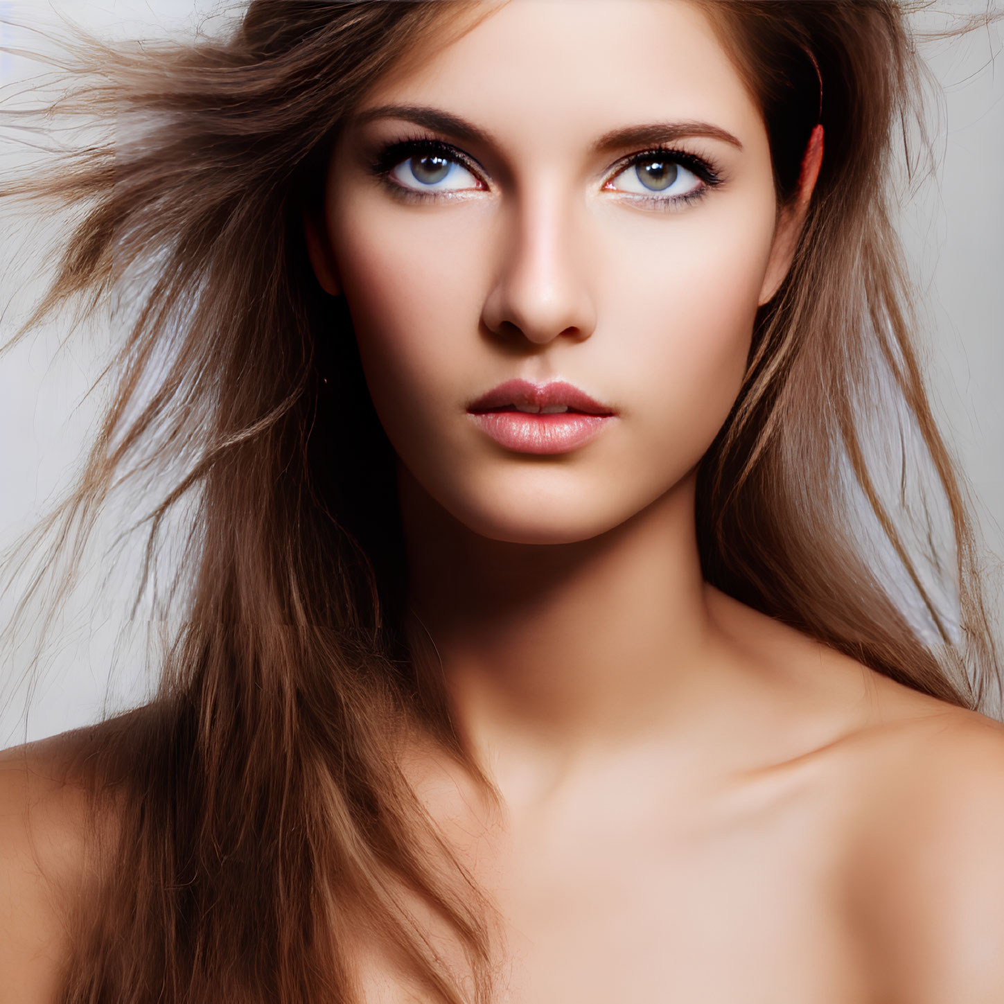 Close-Up Portrait of Woman with Windswept Hair and Intense Eyes