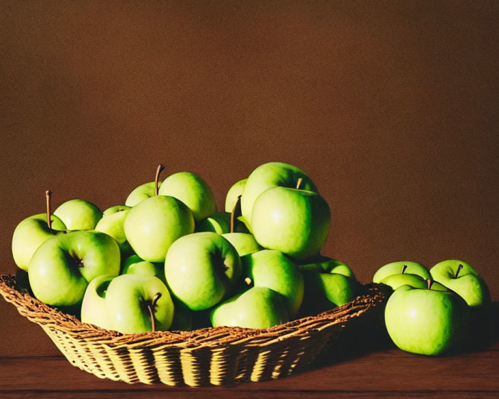 Ripe green apples in a basket on wooden table