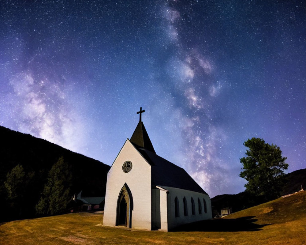 Small Church Under Starry Night Sky with Milky Way Over Dark Hills