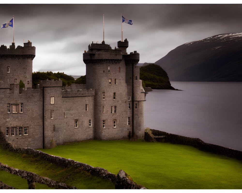 Stone castle with flags, lake, mountains, and greenery under overcast skies