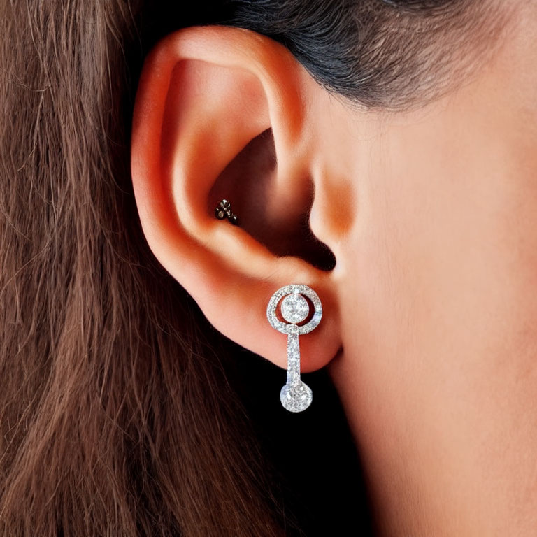 Detailed view of woman's ear with luxurious diamond earrings