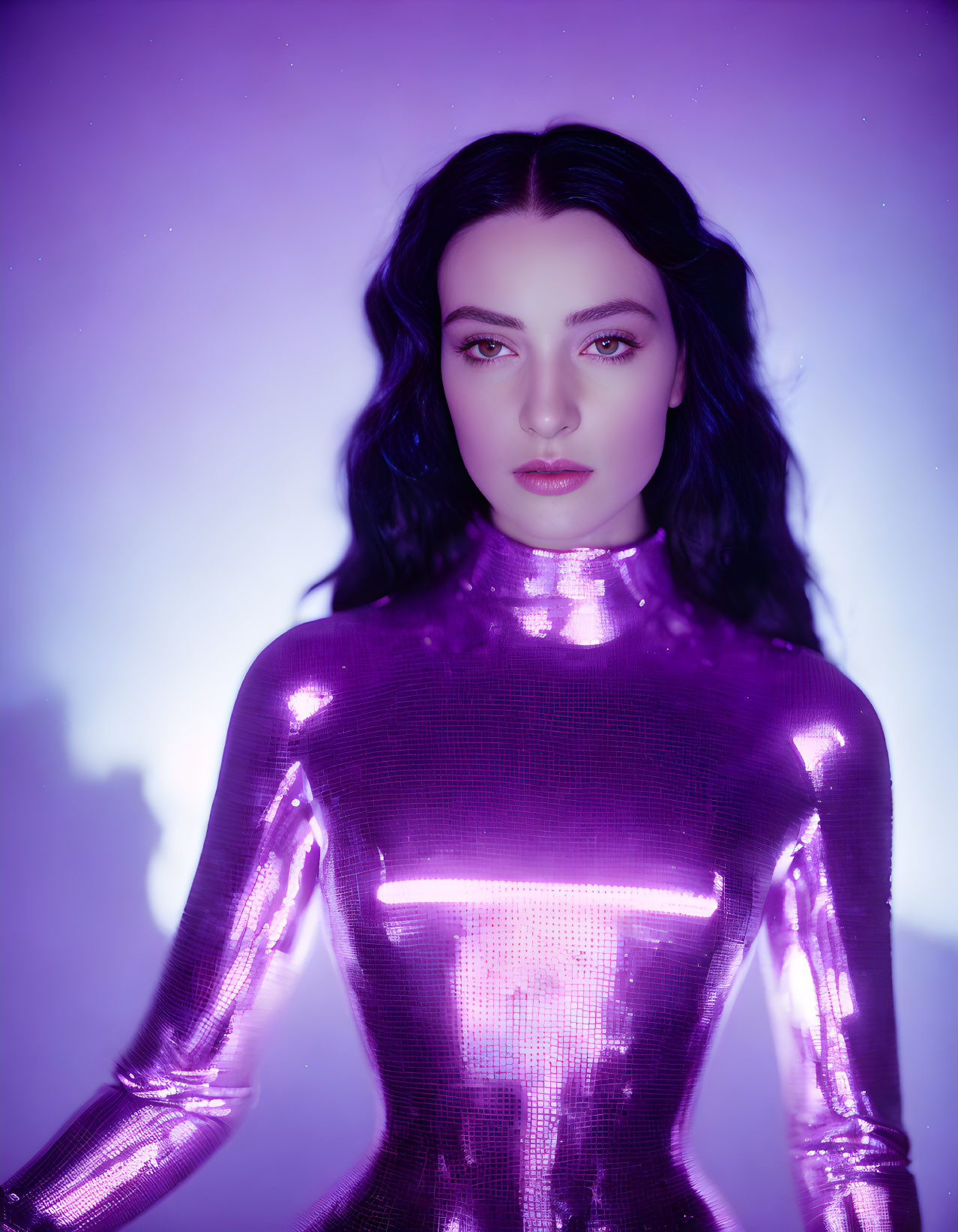 Portrait of woman in metallic purple bodysuit under soft purple light