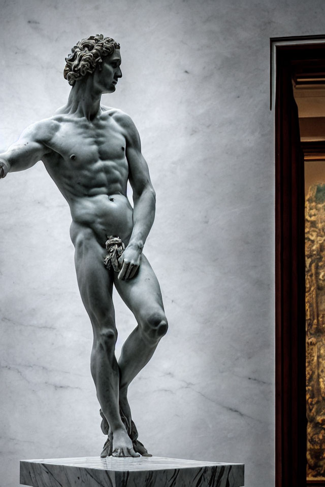 Detailed musculature and poised expression of a David statue in soft lighting