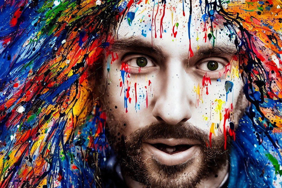 Bearded man with intense gaze covered in colorful paint on blue backdrop