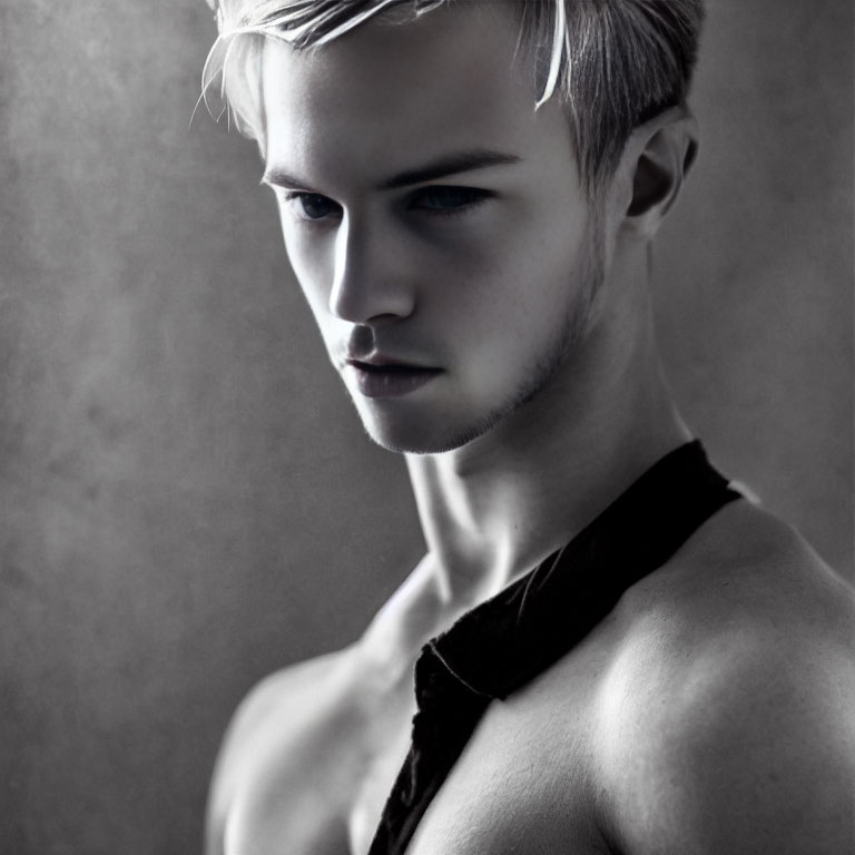 Monochrome portrait of young man with blond hair in pensive expression